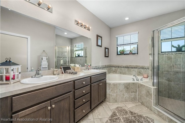 bathroom featuring vanity and separate shower and tub