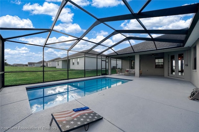 view of pool with a patio, a lanai, ceiling fan, and french doors