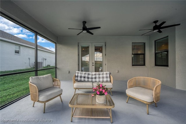 sunroom / solarium featuring french doors and ceiling fan