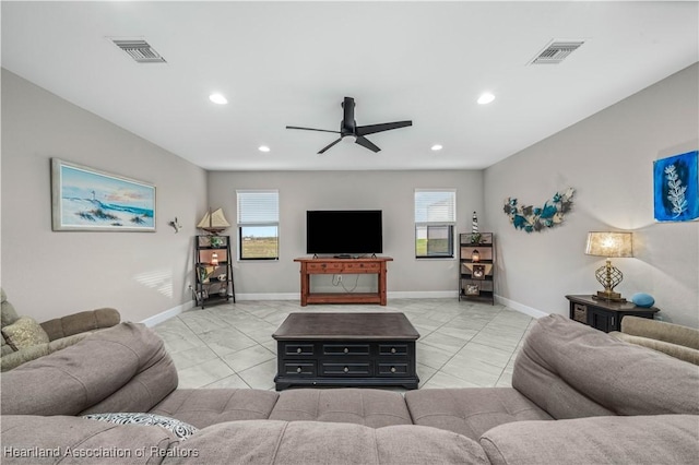 living room with ceiling fan and plenty of natural light