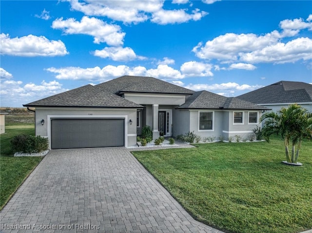 view of front of house featuring a garage and a front yard