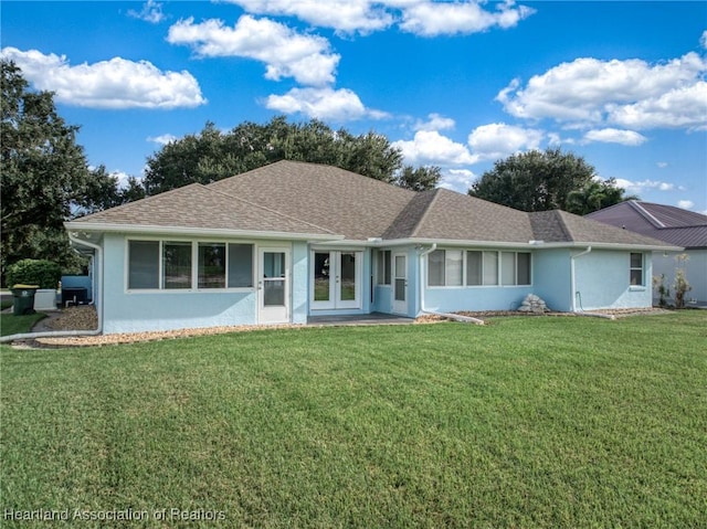 ranch-style house with french doors and a front lawn