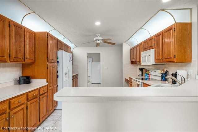 kitchen with white appliances, sink, ceiling fan, light tile patterned floors, and tasteful backsplash