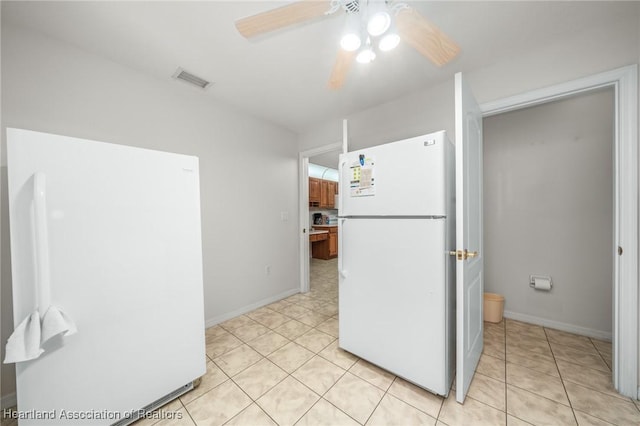 kitchen featuring ceiling fan, white fridge, and light tile patterned floors