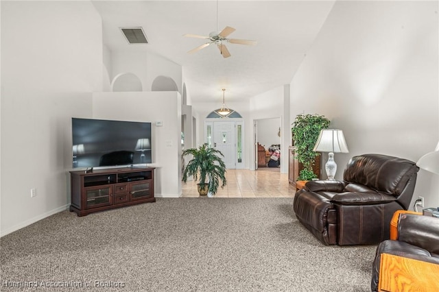 living room with light carpet, ceiling fan, and vaulted ceiling