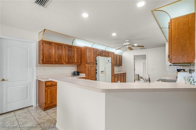 kitchen featuring decorative backsplash, ceiling fan, light tile patterned flooring, and white refrigerator with ice dispenser