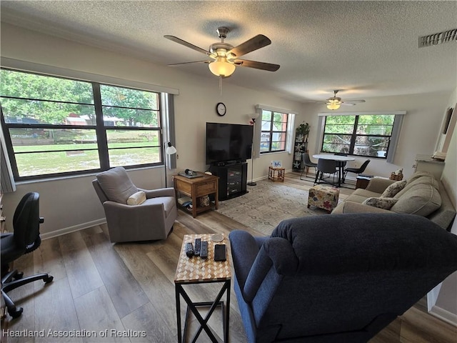 1725 Amber Ln, Lake Placid, FL 33852 - living area with ceiling fan, a textured ceiling, and wood finished floors