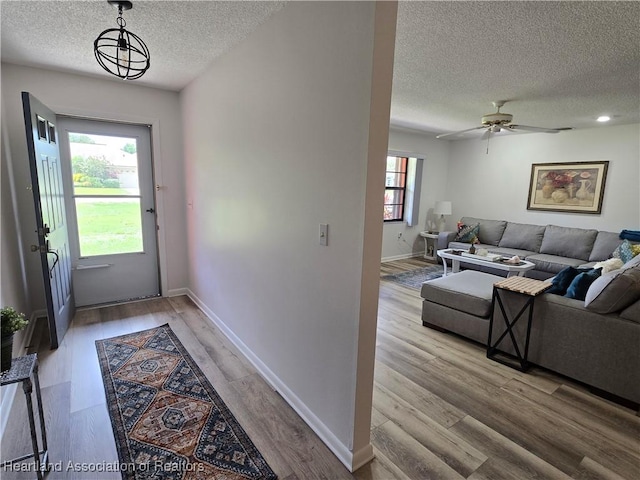 1725 Amber Ln, Lake Placid, FL 33852 - doorway featuring a textured ceiling, light wood-style floors, and a ceiling fan