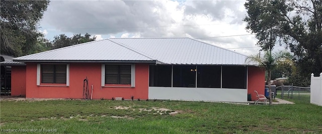 1725 Amber Ln, Lake Placid, FL 33852 - view of side of property with a sunroom, stucco siding, and a metal roof