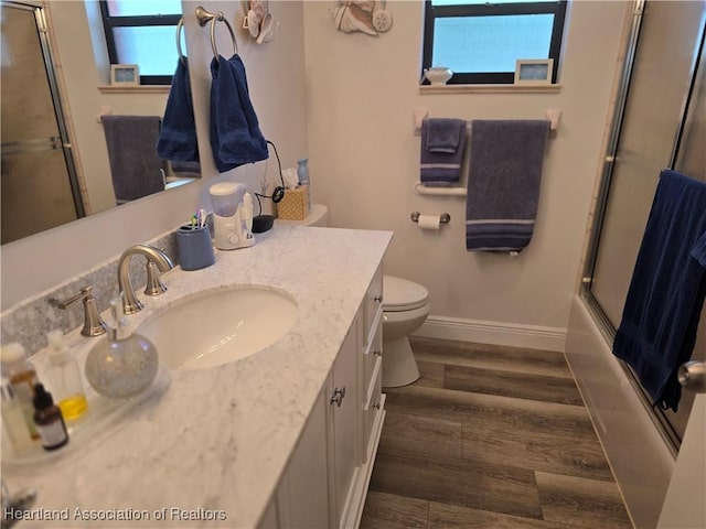 1725 Amber Ln, Lake Placid, FL 33852 - bathroom with vanity, wood finished floors, and bath / shower combo with glass door
