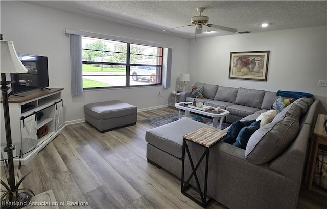 1725 Amber Ln, Lake Placid, FL 33852 - living room featuring a textured ceiling, ceiling fan, and wood finished floors