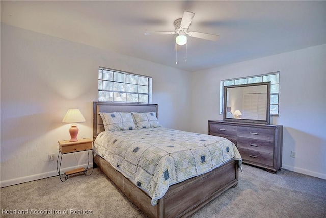 carpeted bedroom featuring ceiling fan and baseboards