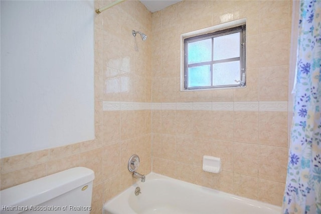 bathroom featuring shower / bathtub combination with curtain and toilet