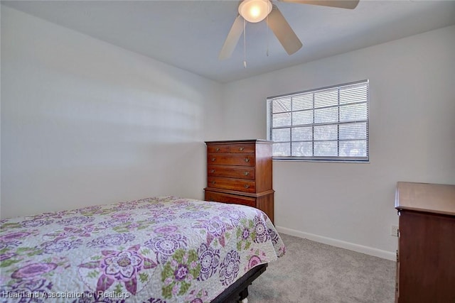 carpeted bedroom featuring ceiling fan and baseboards