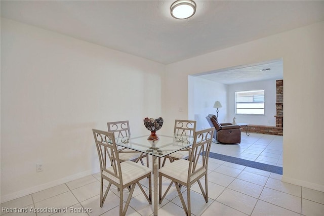 dining room featuring light tile patterned floors and baseboards