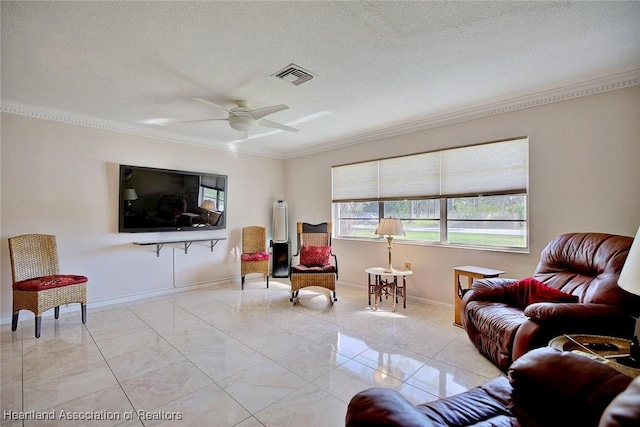 living room featuring a textured ceiling, visible vents, baseboards, a ceiling fan, and ornamental molding