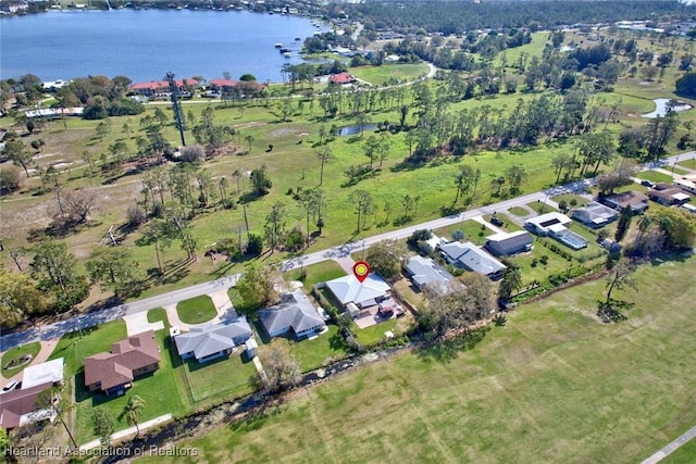 drone / aerial view featuring a water view and a residential view