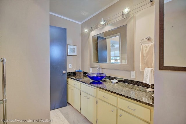 bathroom featuring tile patterned floors, ornamental molding, and vanity