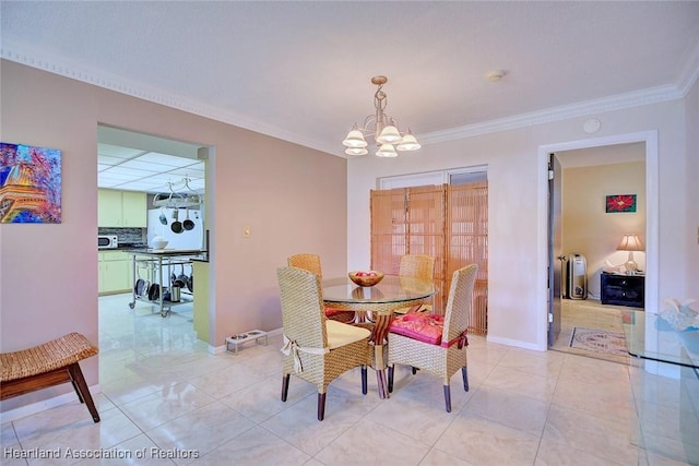 dining space featuring a chandelier, crown molding, baseboards, and light tile patterned floors