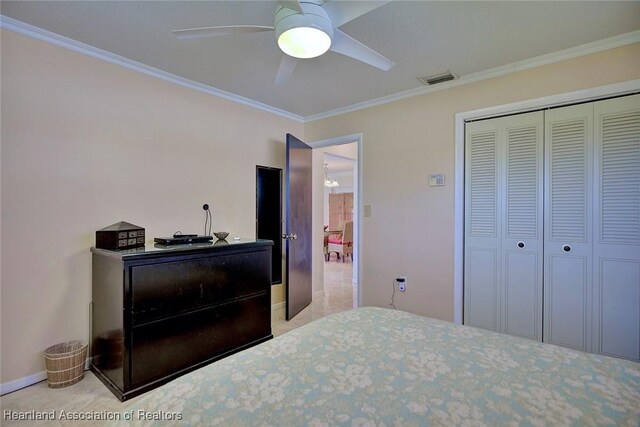 bedroom featuring a ceiling fan, a closet, visible vents, and crown molding