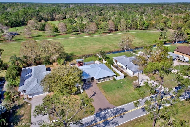 birds eye view of property featuring a forest view