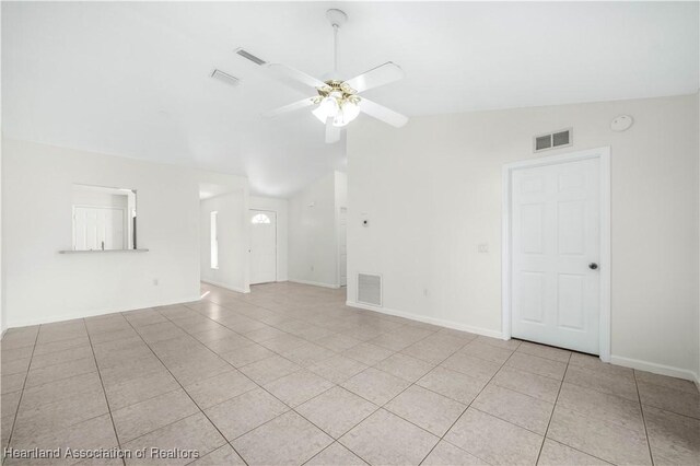 empty room featuring light tile patterned floors, ceiling fan, and lofted ceiling