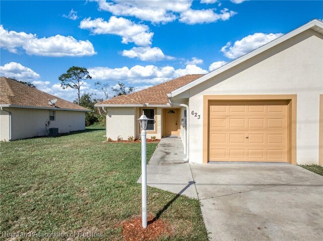 single story home with central AC, a front lawn, and a garage