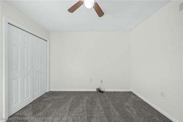 unfurnished bedroom featuring ceiling fan, a closet, and dark carpet