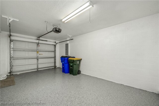 garage featuring electric panel and a garage door opener