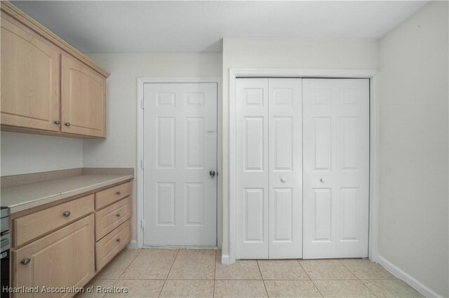 kitchen featuring light brown cabinets and light tile patterned floors