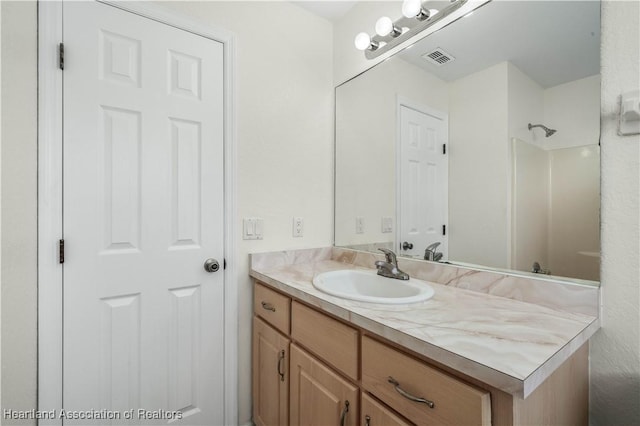 bathroom with vanity and walk in shower