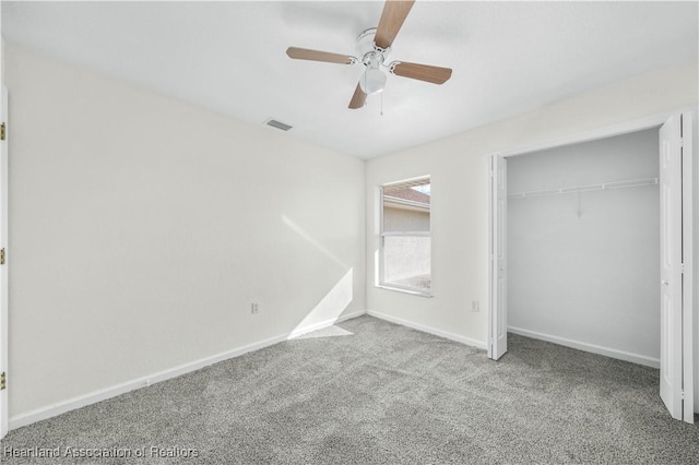 unfurnished bedroom featuring a closet, light colored carpet, and ceiling fan