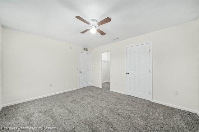 spare room with ceiling fan and carpet floors