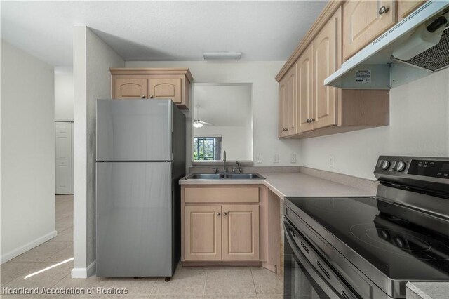 kitchen with light brown cabinetry, ceiling fan, sink, and stainless steel appliances