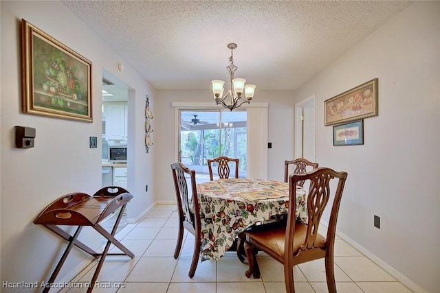 dining room with light tile patterned flooring, a textured ceiling, baseboards, and an inviting chandelier