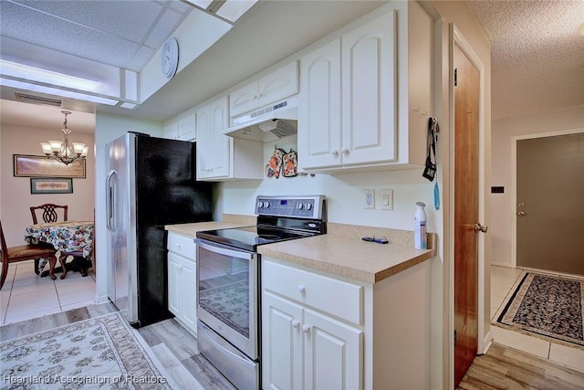 kitchen featuring under cabinet range hood, stainless steel appliances, white cabinetry, visible vents, and light countertops