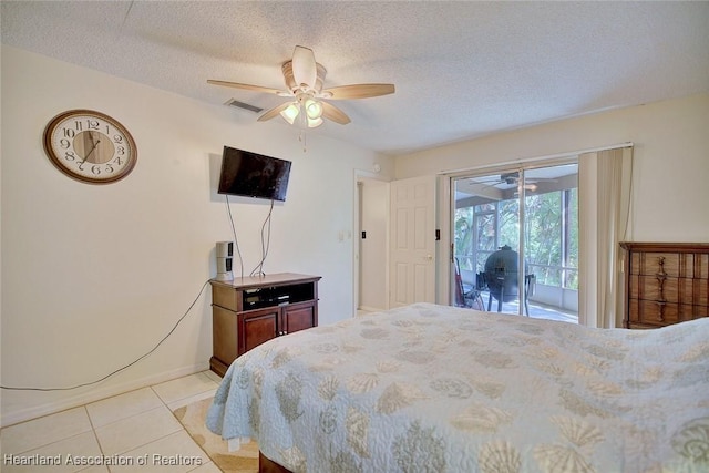 bedroom featuring access to exterior, visible vents, a textured ceiling, and light tile patterned floors