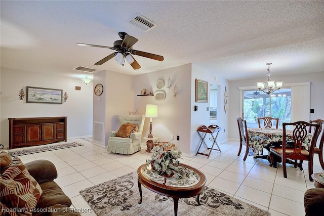 living area with light tile patterned floors, visible vents, and a textured ceiling