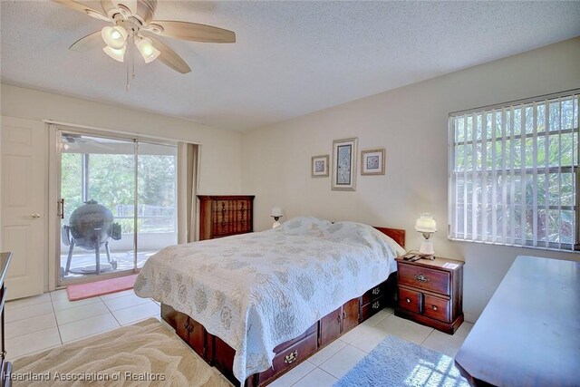 bedroom featuring a textured ceiling, access to outside, light tile patterned flooring, and a ceiling fan