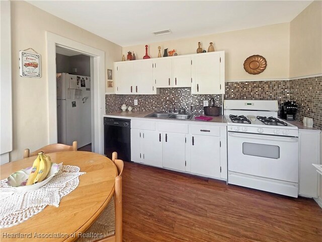 21 N French Ave, Fort Meade, FL 33841 - kitchen with white appliances, a sink, white cabinets, light countertops, and dark wood finished floors