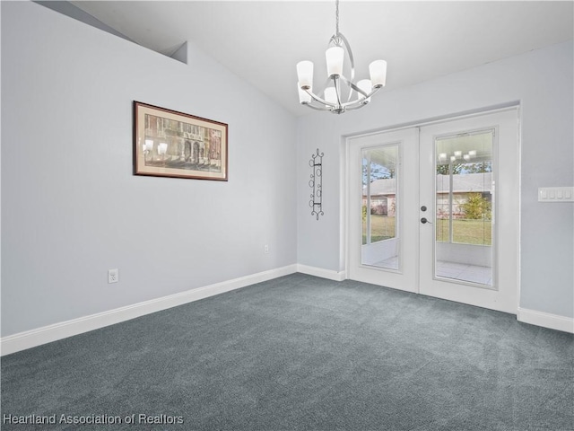 carpeted empty room featuring a chandelier, vaulted ceiling, and french doors