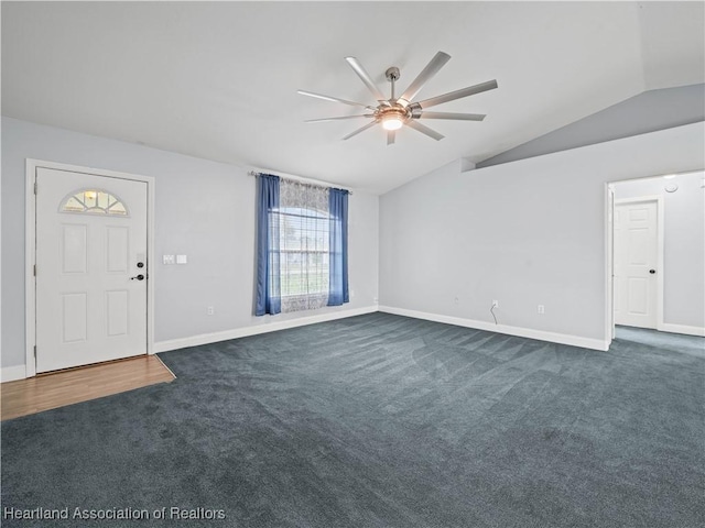 unfurnished living room with dark colored carpet, ceiling fan, and lofted ceiling