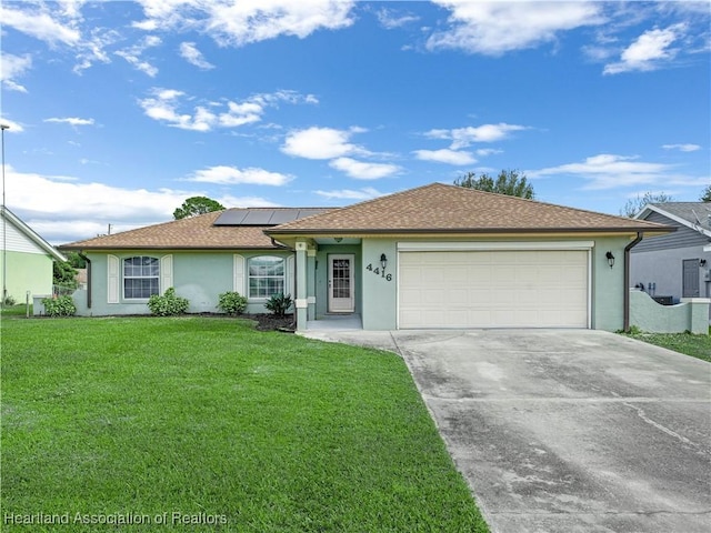 single story home featuring solar panels, a garage, and a front lawn