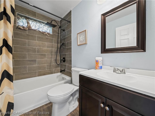 full bathroom with vanity, hardwood / wood-style flooring, toilet, and shower / bath combo with shower curtain