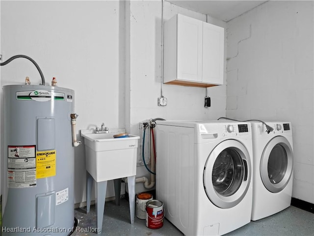 laundry room featuring cabinets, independent washer and dryer, and electric water heater