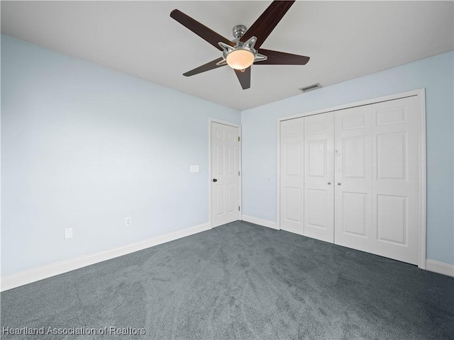 unfurnished bedroom featuring a closet, dark carpet, and ceiling fan