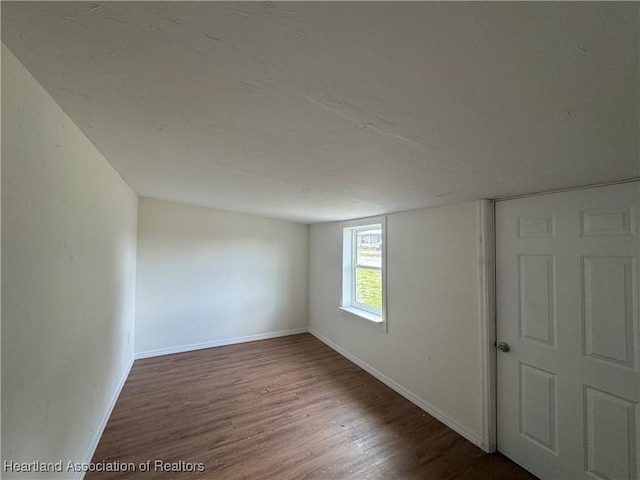 4504 High Ave, Sebring, FL 33870 - empty room with wood finished floors and baseboards