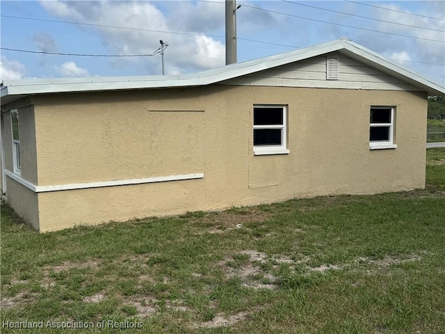 4504 High Ave, Sebring, FL 33870 - view of home's exterior featuring stucco siding and a yard