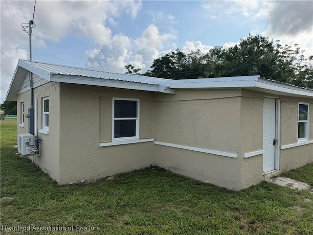 4504 High Ave, Sebring, FL 33870 - view of side of home with stucco siding, a lawn, central air condition unit, and metal roof