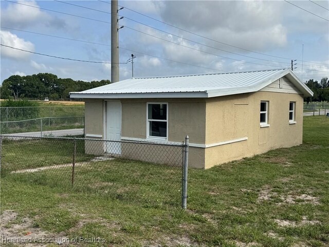 4504 High Ave, Sebring, FL 33870 - view of side of home with stucco siding and metal roof